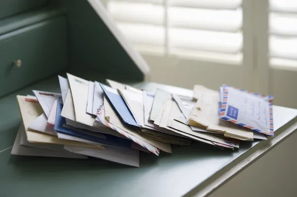 this picture shows a stack of envelopes that could potentially be sent with cash inside of them