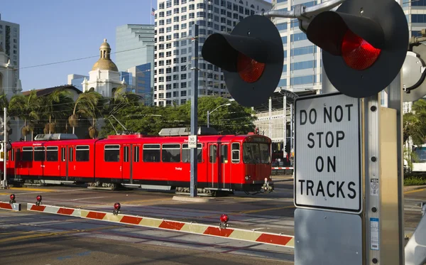 this photo is of train tracks with a train on it with a sign saying do not stop on tracks