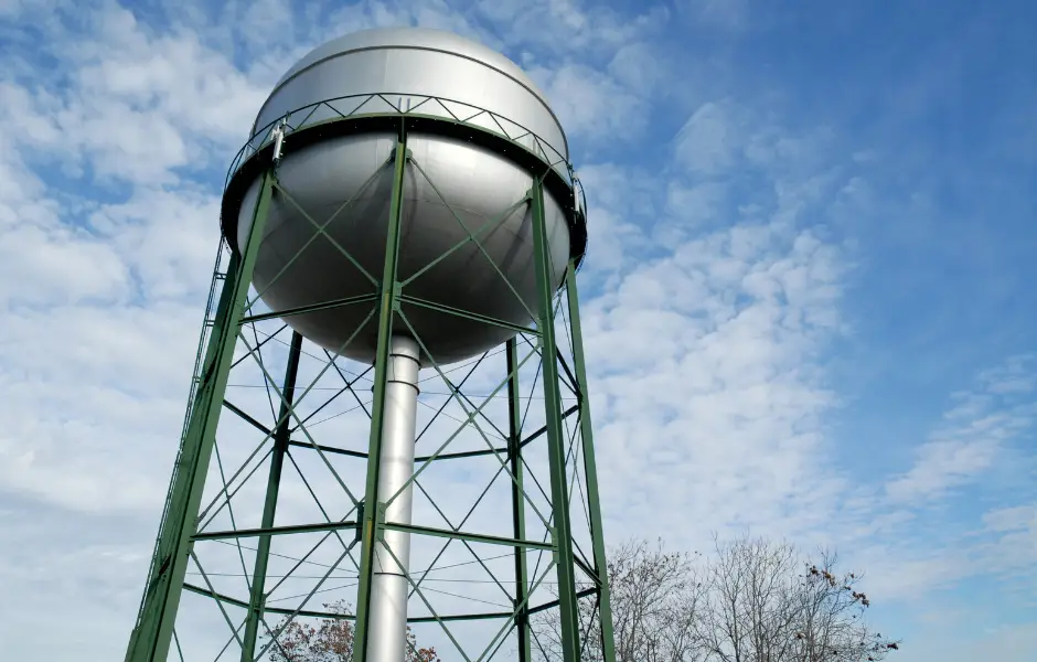photo of a water tower with sky in background
