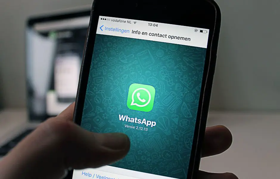this is a photo of a phone about to take a screenshot of it's whatsapp screen